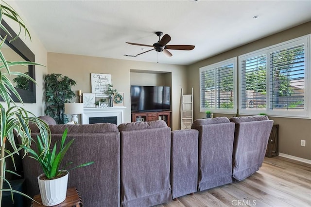 4765 Falconview Ct, Fontana, CA 92336 - living room featuring a ceiling fan, wood finished floors, and a fireplace