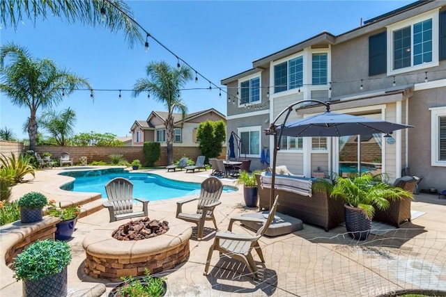 4765 Falconview Ct, Fontana, CA 92336 - view of swimming pool with a fenced backyard, a patio area, and an outdoor living space with a fire pit