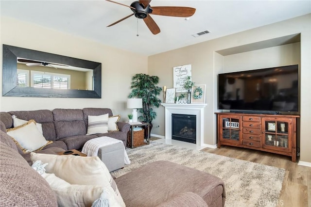 4765 Falconview Ct, Fontana, CA 92336 - living area with ceiling fan, wood finished floors, and a glass covered fireplace