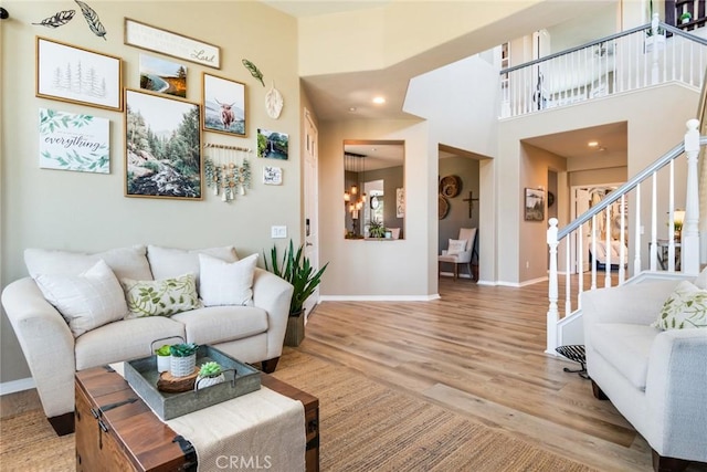 4765 Falconview Ct, Fontana, CA 92336 - living room featuring stairway, wood finished floors, and a chandelier