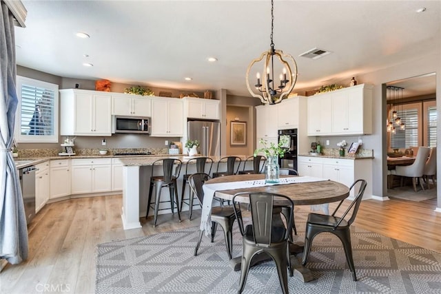 4765 Falconview Ct, Fontana, CA 92336 - dining area with a chandelier, light wood finished floors, and recessed lighting