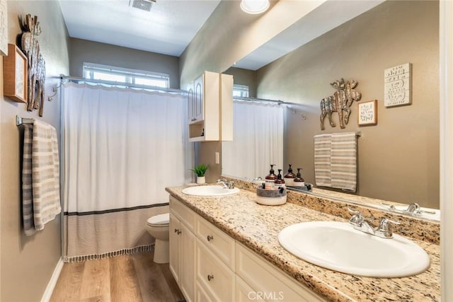 4765 Falconview Ct, Fontana, CA 92336 - bathroom featuring double vanity, wood finished floors, and curtained shower
