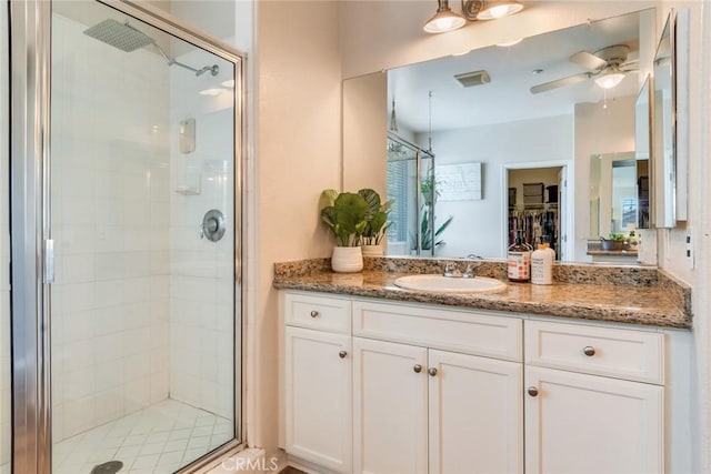 4765 Falconview Ct, Fontana, CA 92336 - bathroom featuring a stall shower, vanity, and ceiling fan