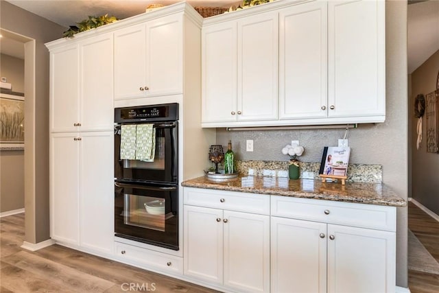 4765 Falconview Ct, Fontana, CA 92336 - kitchen featuring light wood-type flooring, stone countertops, white cabinets, and tasteful backsplash