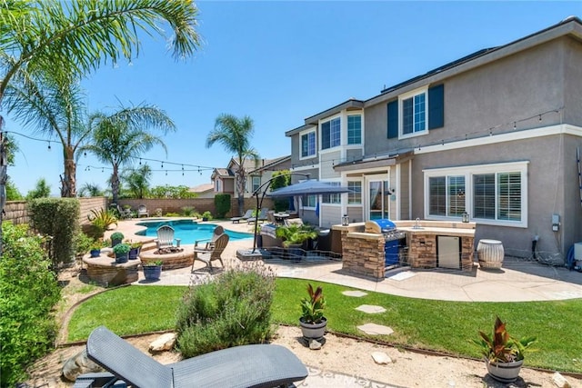 4765 Falconview Ct, Fontana, CA 92336 - view of swimming pool featuring an outdoor kitchen, a fenced backyard, a patio, and an outdoor fire pit