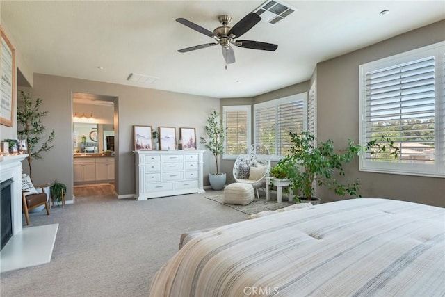 4765 Falconview Ct, Fontana, CA 92336 - bedroom featuring carpet floors, a fireplace with raised hearth, connected bathroom, and ceiling fan