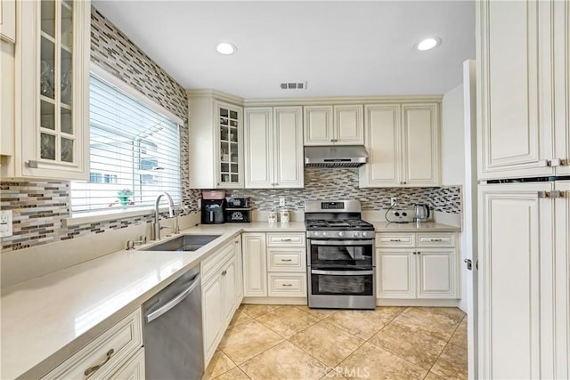 518 Hawthorne St, Glendale, CA 91204 - kitchen with stainless steel appliances, range hood, a sink, tasteful backsplash, and light countertops
