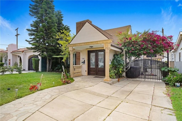518 Hawthorne St, Glendale, CA 91204 - shotgun-style home featuring french doors, a front lawn, a gate, a chimney, and stucco siding