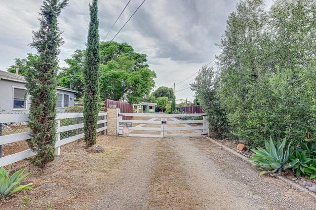 123 N Hayden Dr, Escondido, CA 92027 - view of dirt / gravel driveway featuring a gate