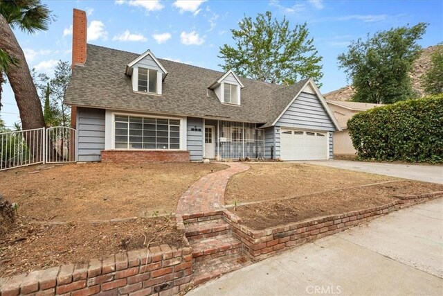 895 Huston Dr, Riverside, CA 92507 - cape cod home with driveway, a chimney, an attached garage, and roof with shingles