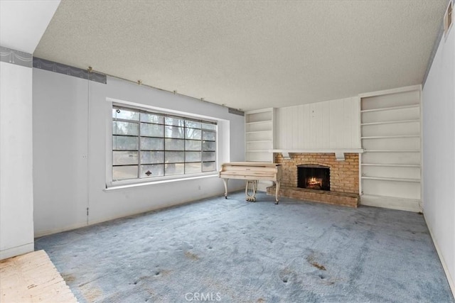 895 Huston Dr, Riverside, CA 92507 - unfurnished living room with a textured ceiling, carpet floors, a fireplace, and built in shelves