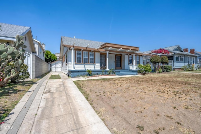 1139 N Heliotrope Dr, Los Angeles, CA 90029 - view of front of house with a porch, concrete driveway, and a gate