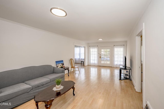 1139 N Heliotrope Dr, Los Angeles, CA 90029 - living area with light wood-style flooring, ornamental molding, and baseboards