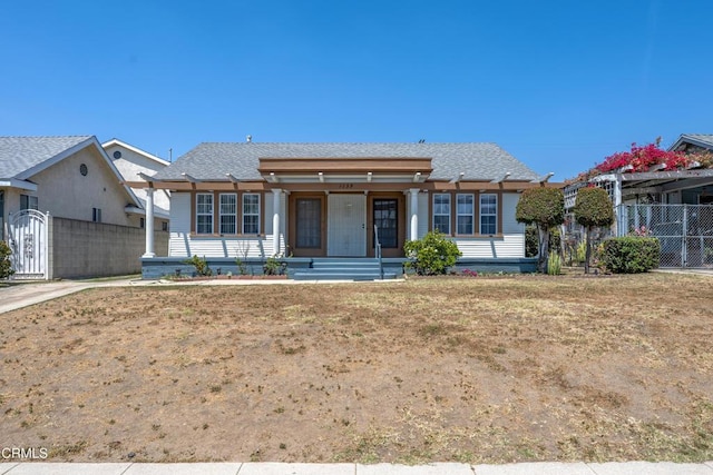 1139 N Heliotrope Dr, Los Angeles, CA 90029 - view of front facade featuring covered porch and roof with shingles