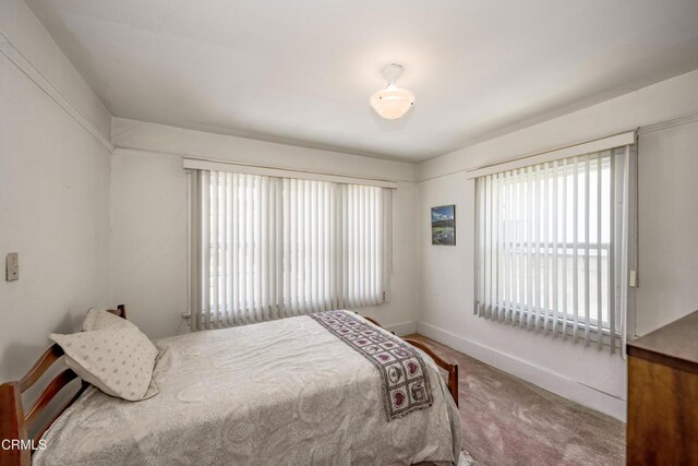 1139 N Heliotrope Dr, Los Angeles, CA 90029 - bedroom with multiple windows, baseboards, and carpet floors
