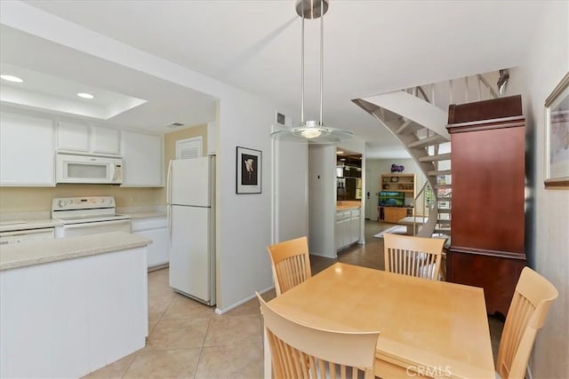 72864 Roy Emerson Ln, Palm Desert, CA 92260 - dining area featuring light tile patterned floors, recessed lighting, and a tray ceiling