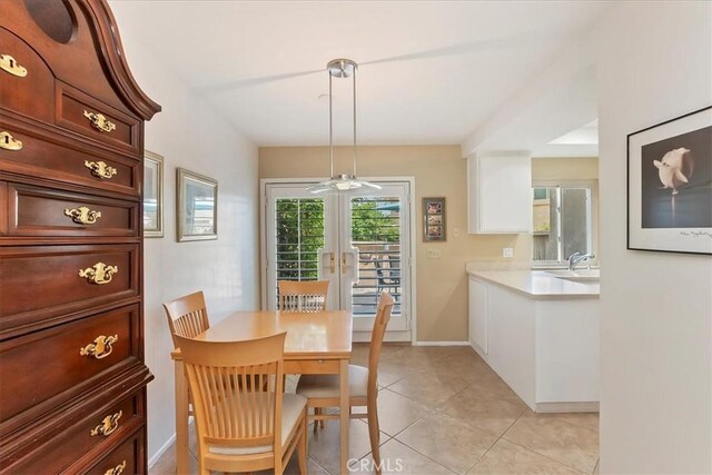 72864 Roy Emerson Ln, Palm Desert, CA 92260 - dining space with light tile patterned floors, french doors, ceiling fan, and baseboards