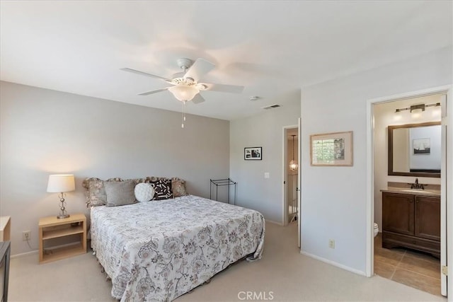 72864 Roy Emerson Ln, Palm Desert, CA 92260 - bedroom with a sink, light colored carpet, baseboards, ensuite bath, and a ceiling fan