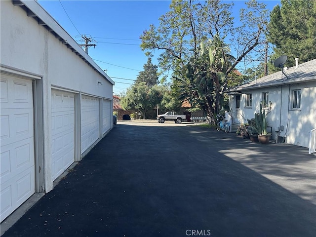 25352543 Cross St, La Crescenta, CA 91214 - view of asphalt driveway featuring community garages