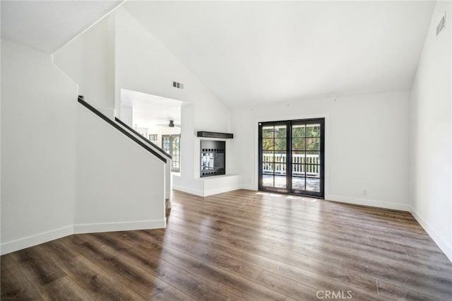 18675 La Ventana Rd, Murrieta, CA 92562 - unfurnished living room with high vaulted ceiling, wood finished floors, stairway, baseboards, and a glass covered fireplace