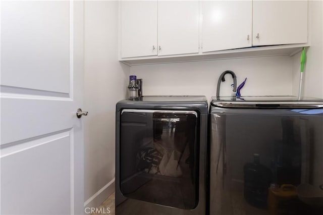 9434 Mclennan Ave, Northridge, CA 91343 - laundry room with cabinet space, washer and clothes dryer, and baseboards