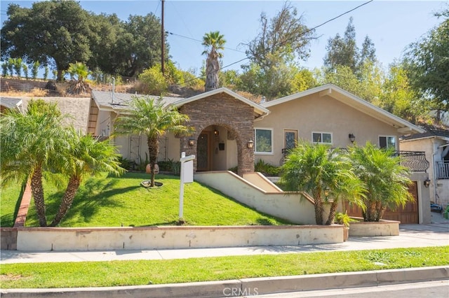 9434 Mclennan Ave, Northridge, CA 91343 - view of front of home with a front lawn, stucco siding, stone siding, concrete driveway, and an attached garage