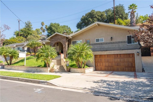 9434 Mclennan Ave, Northridge, CA 91343 - view of front of house with driveway, stucco siding, an attached garage, and stairs