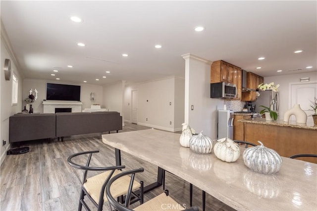 9434 Mclennan Ave, Northridge, CA 91343 - dining space with baseboards, crown molding, recessed lighting, and light wood-style floors