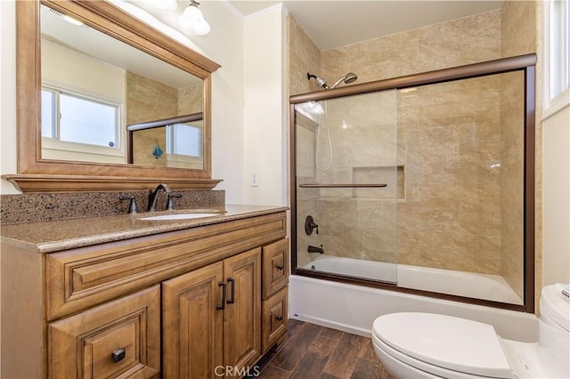 9434 Mclennan Ave, Northridge, CA 91343 - bathroom featuring toilet, vanity, bath / shower combo with glass door, and wood finished floors