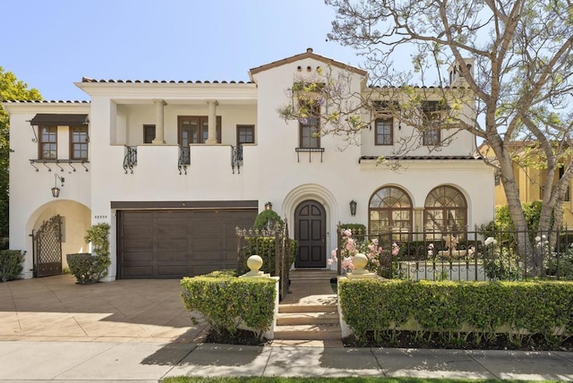 13335 Seagrove St, Carmel Valley, CA 92130 - mediterranean / spanish house featuring a balcony, stucco siding, a garage, and concrete driveway