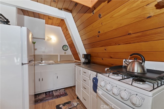 31115 All View Dr, Running Springs, CA 92382 - kitchen with white appliances, white cabinetry, a sink, light wood-type flooring, and lofted ceiling