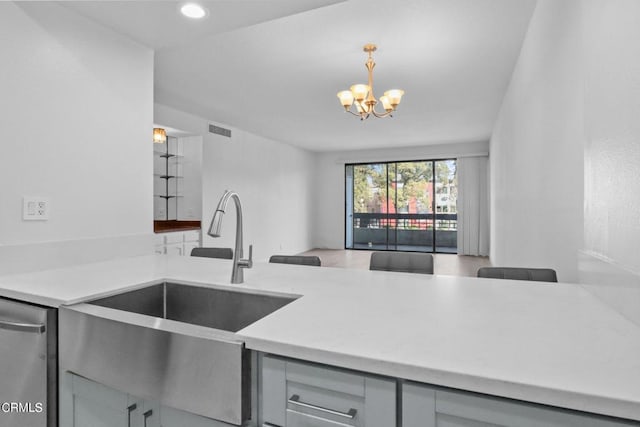 435 La Fayette Park Pl Unit 102, Los Angeles, CA 90057 - kitchen with a sink, a chandelier, stainless steel dishwasher, open floor plan, and light countertops