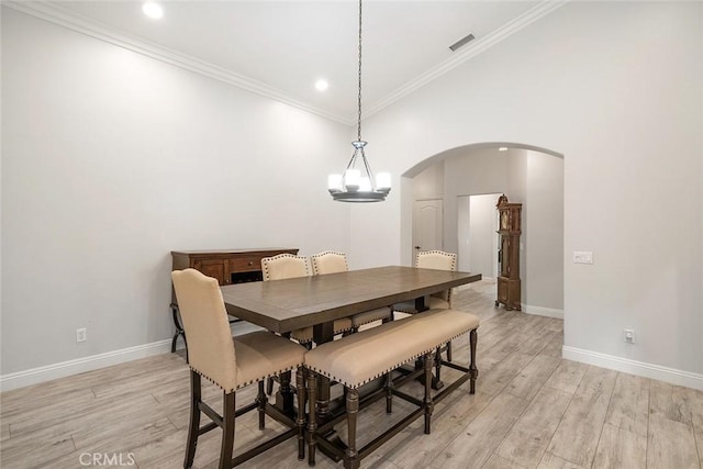 23592 Beech St, Hemet, CA 92545 - dining area featuring arched walkways, light wood finished floors, baseboards, ornamental molding, and recessed lighting