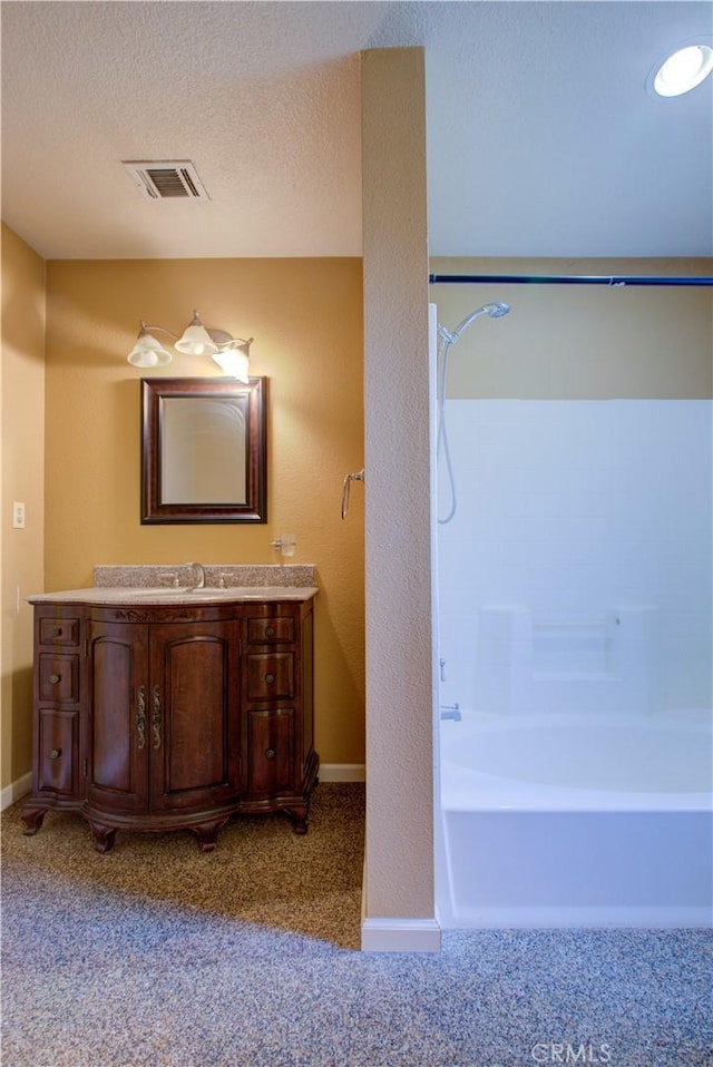 2001 5th St, Atwater, CA 95301 - full bath with washtub / shower combination, vanity, baseboards, and a textured ceiling