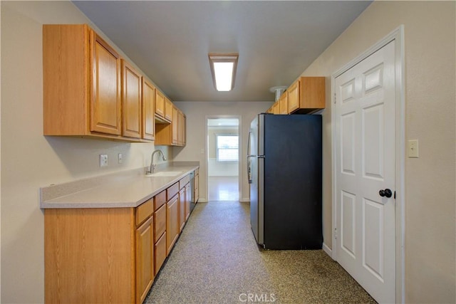 2001 5th St, Atwater, CA 95301 - kitchen featuring freestanding refrigerator, a sink, light countertops, and baseboards