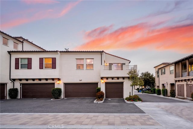 144 Borrego, Irvine, CA 92618 - townhome / multi-family property featuring a garage, stucco siding, driveway, and a tile roof