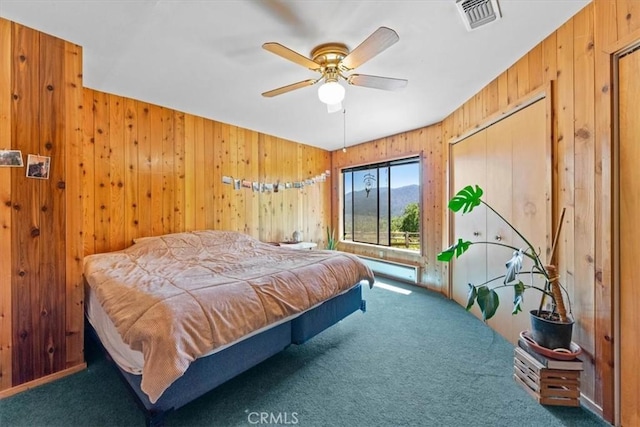 125 Cedar Gulch Rd, Hayfork, CA 96041 - carpeted bedroom featuring wooden walls, a baseboard radiator, and a ceiling fan