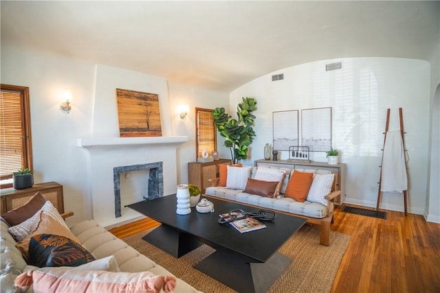 2691 Golden Ave, Long Beach, CA 90806 - living area with wood-type flooring, a fireplace, baseboards, and lofted ceiling