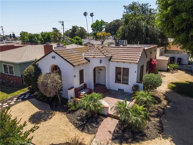 2691 Golden Ave, Long Beach, CA 90806 - mediterranean / spanish house with stucco siding, a tile roof, a chimney, and cooling unit