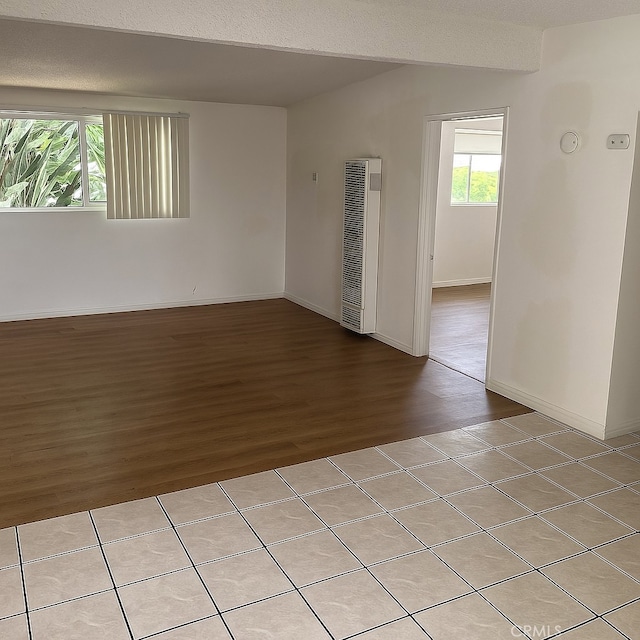 12905 Palm St, Garden Grove, CA 92840 - spare room with a heating unit, light wood-style floors, plenty of natural light, and baseboards