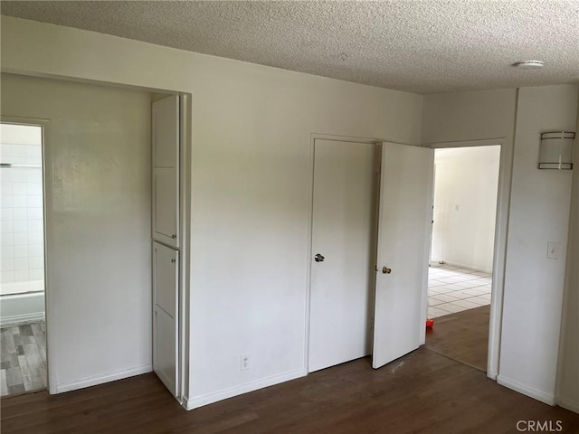 12905 Palm St, Garden Grove, CA 92840 - unfurnished bedroom featuring dark wood finished floors and a textured ceiling