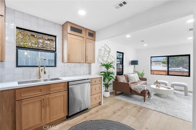 2220 Halladay St, Santa Ana, CA 92707 - kitchen with stainless steel dishwasher, a sink, backsplash, light countertops, and recessed lighting