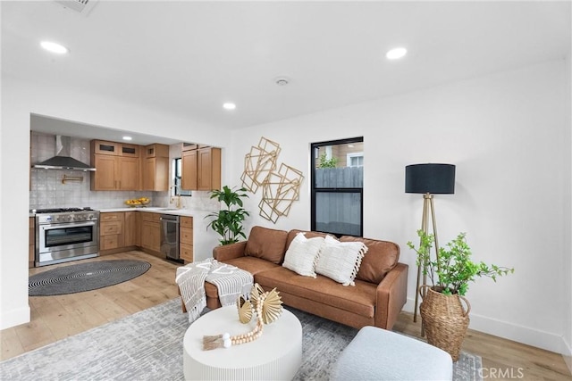 2220 Halladay St, Santa Ana, CA 92707 - living area featuring light wood-style flooring, baseboards, and recessed lighting
