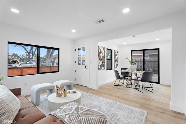 2220 Halladay St, Santa Ana, CA 92707 - living area featuring plenty of natural light, light wood-type flooring, recessed lighting, and baseboards
