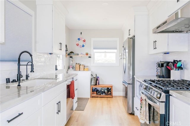 11304 Oklahoma Ave, South Gate, CA 90280 - kitchen featuring range hood, stainless steel appliances, a sink, light stone counters, and decorative backsplash