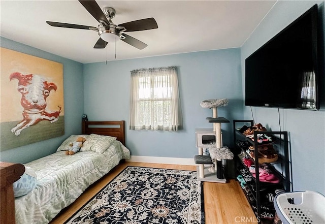11304 Oklahoma Ave, South Gate, CA 90280 - bedroom with wood finished floors, a ceiling fan, and baseboards