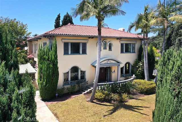 101 S Windsor Blvd, Los Angeles, CA 90004 - mediterranean / spanish home with stucco siding, a tiled roof, a front lawn, and a porch