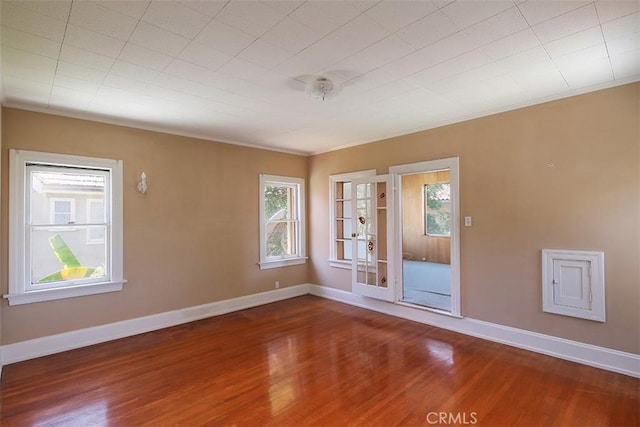 101 S Windsor Blvd, Los Angeles, CA 90004 - spare room featuring plenty of natural light, wood finished floors, and baseboards