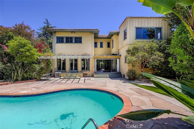 101 S Windsor Blvd, Los Angeles, CA 90004 - rear view of property with a pergola, a patio, an outdoor pool, and a tile roof