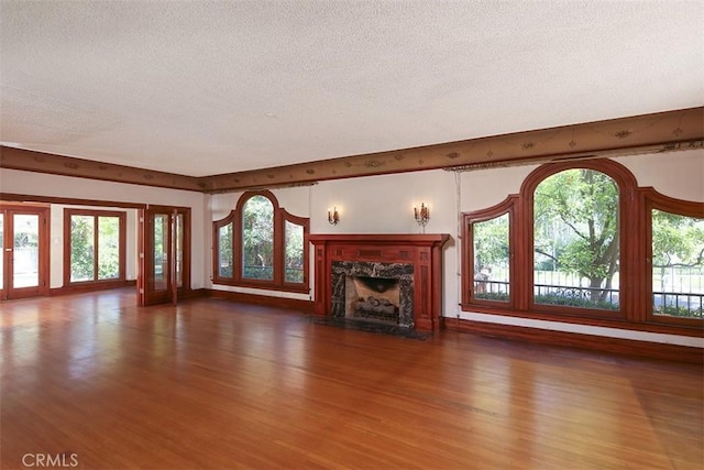 101 S Windsor Blvd, Los Angeles, CA 90004 - unfurnished living room featuring a textured ceiling, wood finished floors, and a high end fireplace